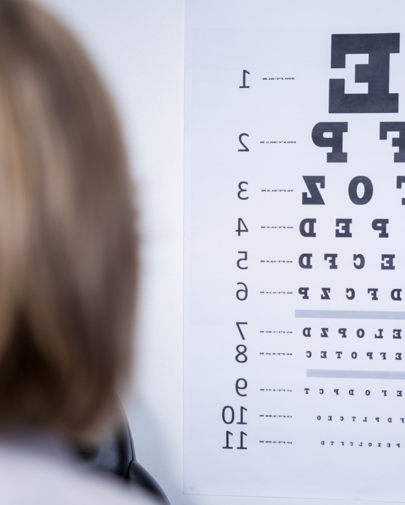 optometrist-looking-at-eye-chart-e1727356037684.jpg